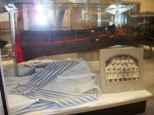 Display case with nursing uniform and historic photograph