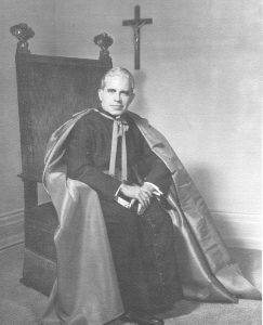 Black and white image of Bishop John Joseph Dougherty seated, c. 1960s