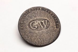 Brass button that says, "G.W. - Long Live the President"