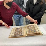Librarian shows medieval text to students