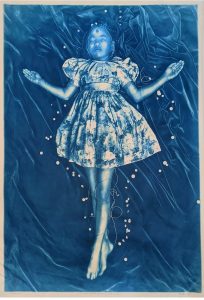 cyanotype depicting a young girl in a dress