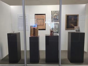 Exhibit featuring several texts, artifacts and a painting of Saint Francis