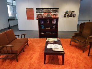 Depiction of an immersive art exhibit featuring a 1970s style living room.