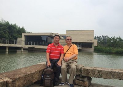With Librarian Hong Cheng (程洪) of UCLA with Muxin (木心) Museum in the background in Wuzhen Water Town