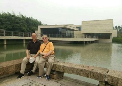 With Librarian Guoqing Li (李国庆) of Ohio State University with Muxin (木心) Museum in the background in Wuzhen Water Town