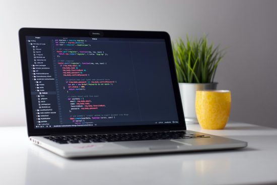 Opened laptop showing coding in screen