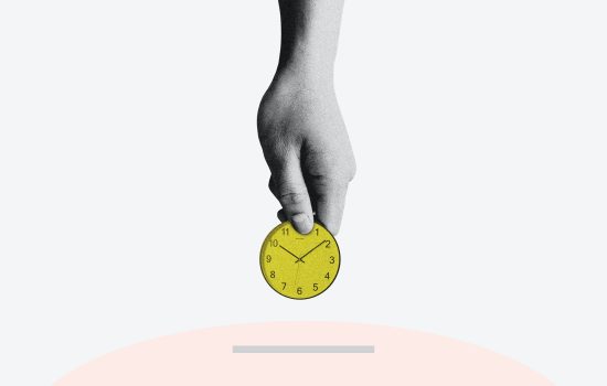 Hand putting a clock shaped coin into a slot