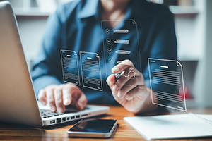 Businesswoman using digital device signs electronic documents online. Paperless workplace idea, e-signing, electronic signature, Technology and document management.