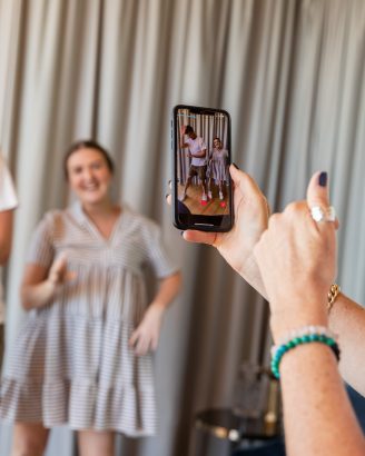 Photo of someone taking a photo of a social media influencer 