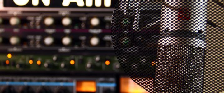 picture of microphone in a radio studio with On Air in the background