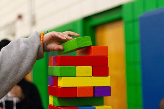 A child building with different colored blocks