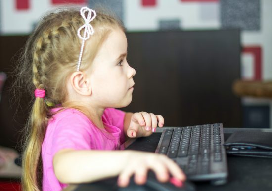 Picture of little girl using computer
