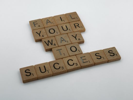 Image of scrabble tiles lettering "Fail Your Way To Success"