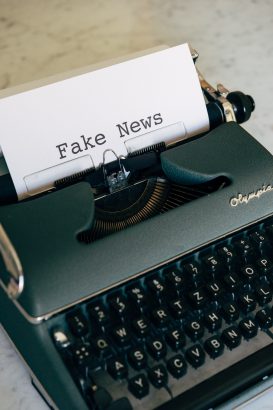 A typewriter printing "Fake News"