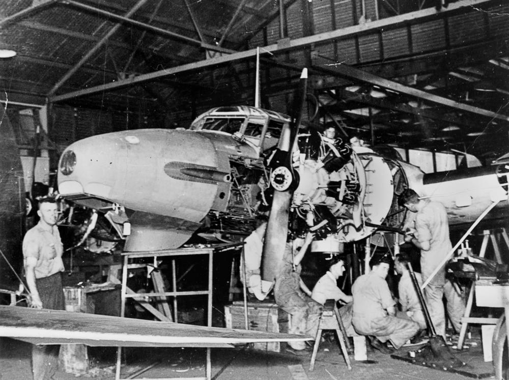 Aircraft mechanics working on an Avro Anson Mk1 plane in Archerfield, CA. From Wikimedia Commons.