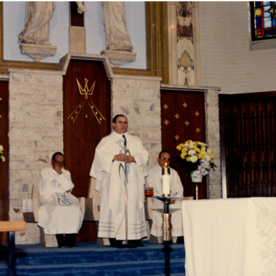 Father Raúl Comesañas preaching inside a church.