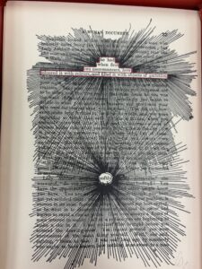 page of A Humument (1973) with black pen crossing out all text except for a few words circled in red. 