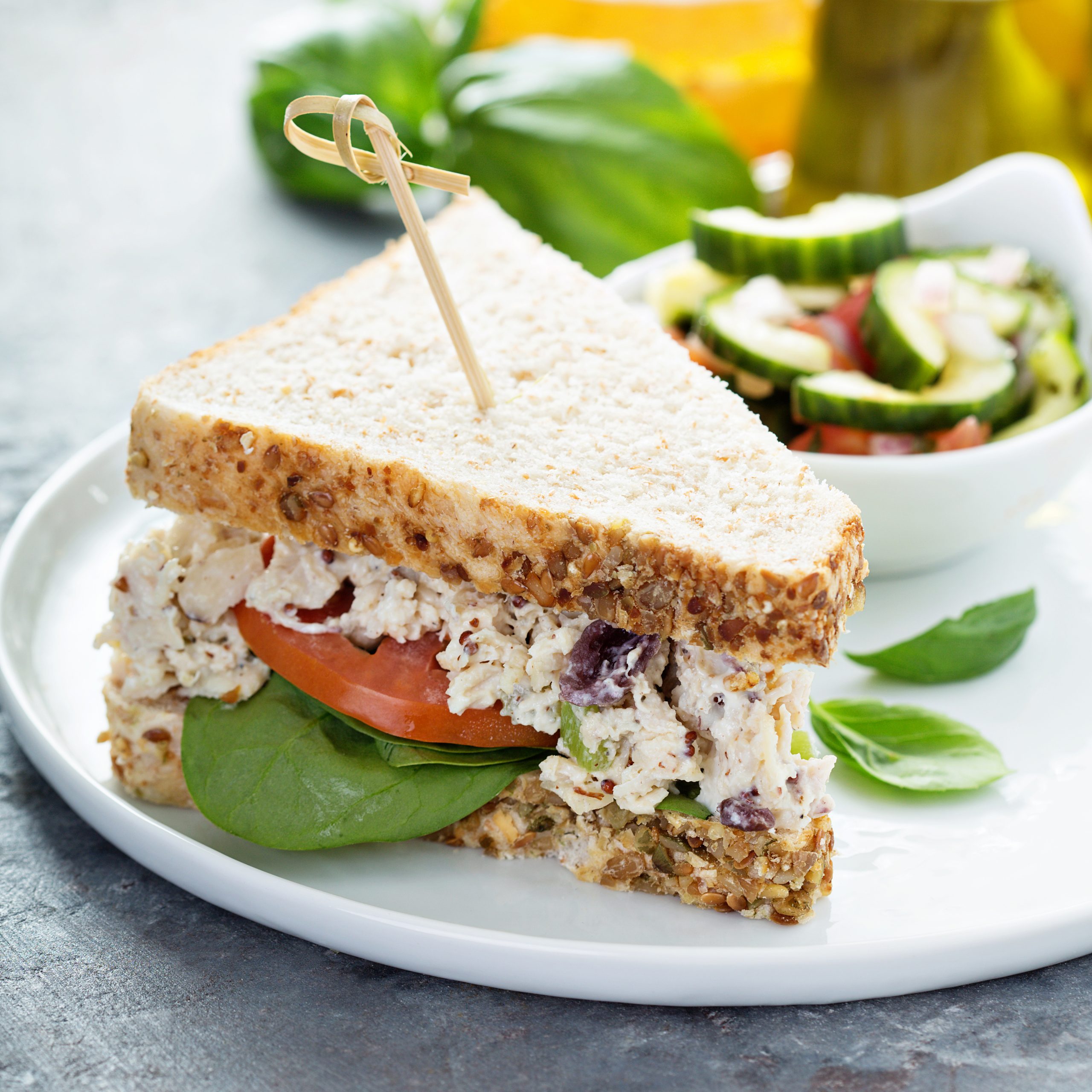 Chicken salad sandwich with spinach and tomato