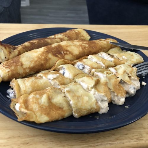 four palacsintas on a blue plate