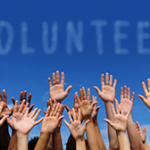 volunteer group raising hands