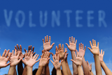 volunteer group raising hands