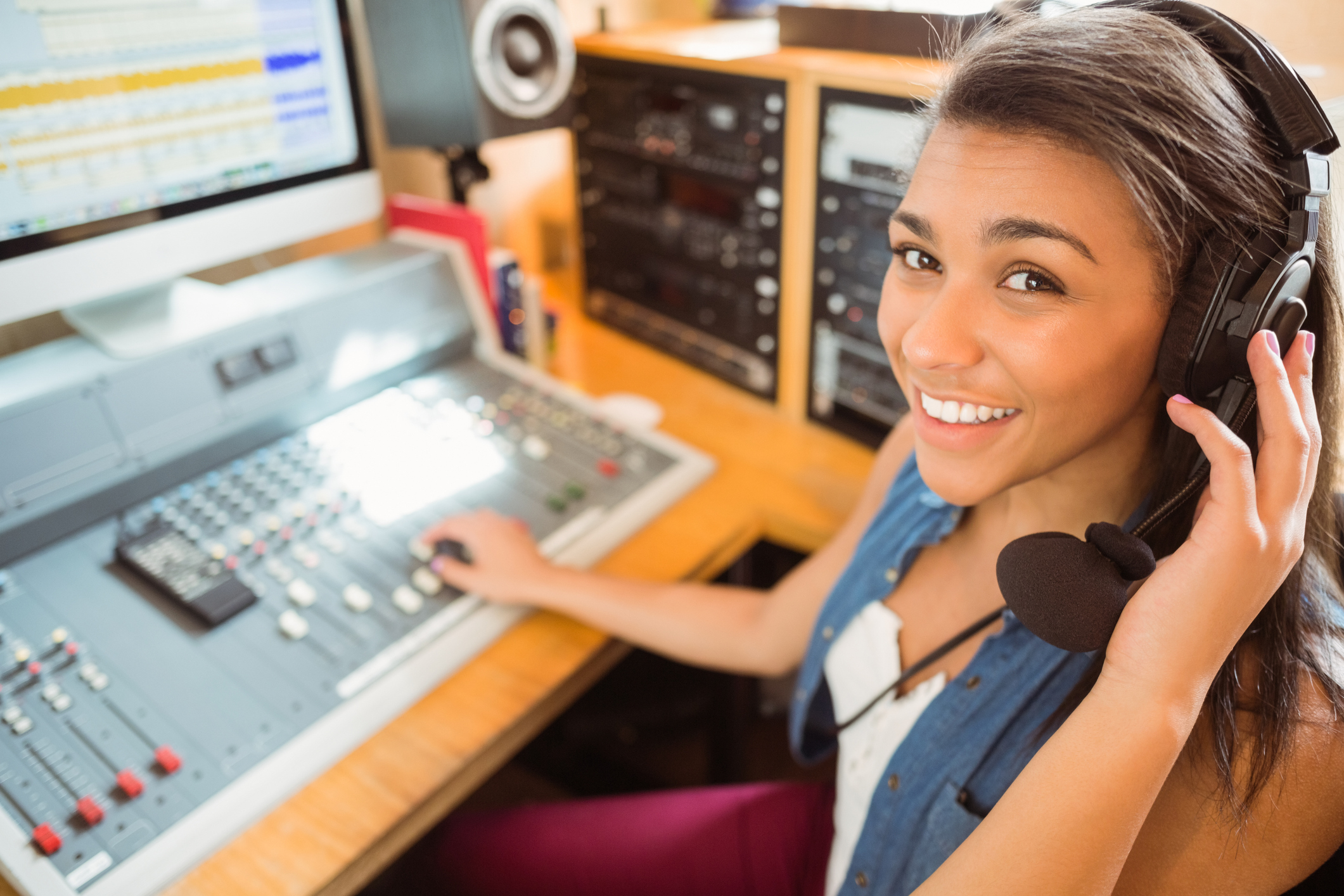 Smiling university student mixing audio