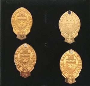 Photo of service pins for 10, 15, 25, and 30 years