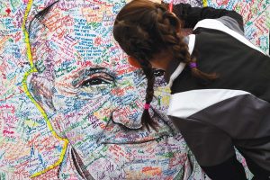 The faithful sign a portrait of Pope Francis after his visit to Independence Hall in Philadelphia. Photo: Richard Perry, The New York Times.