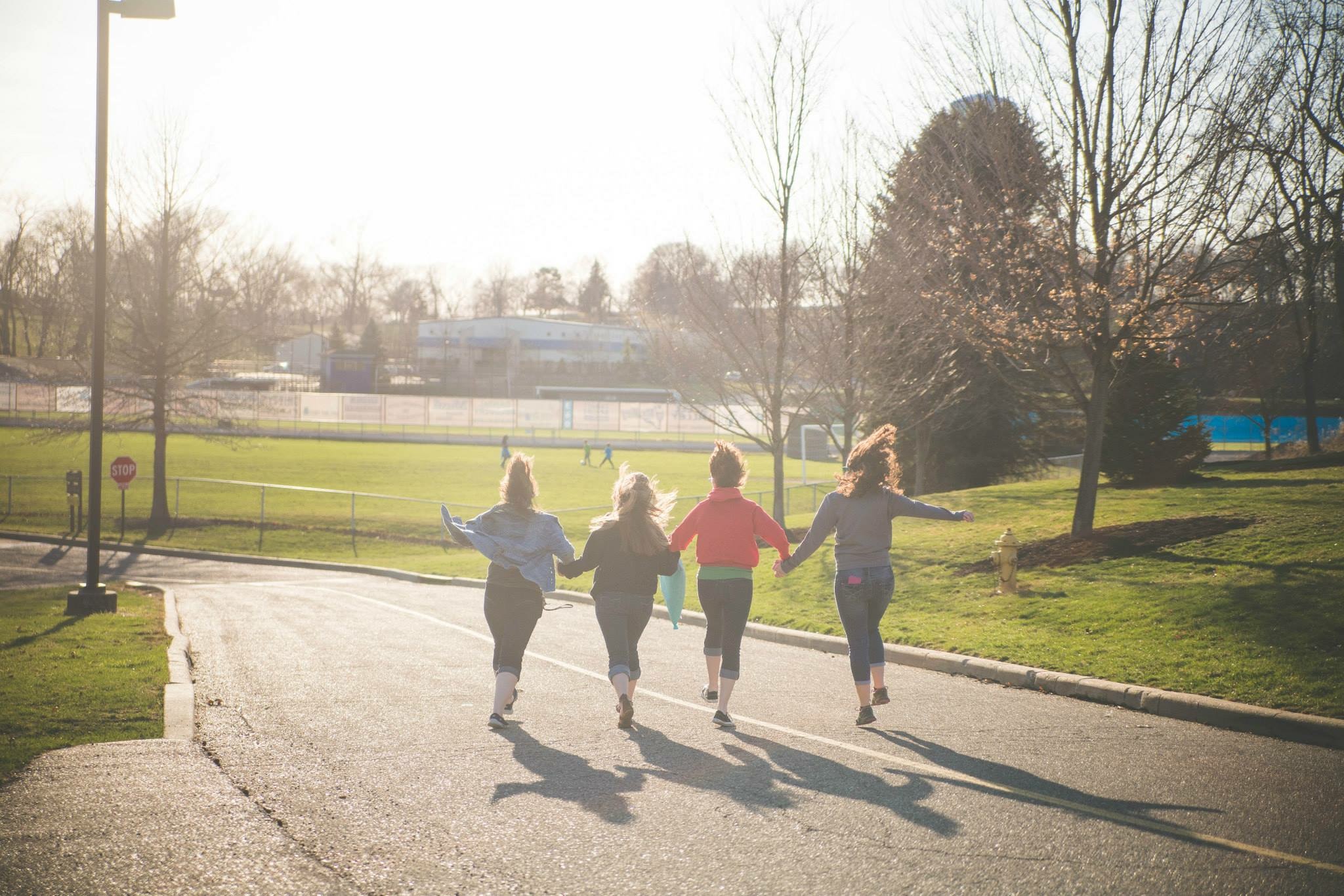 College Friends Skipping Through the Streets