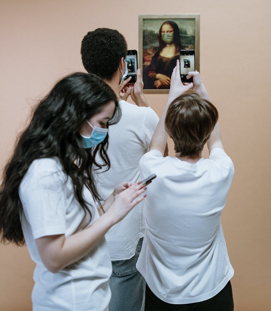 People in Masks Taking Pictures of the Mona Lisa