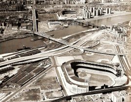 Yankee Stadium and the Polo Grounds looking each other down across the Harlem River. The Macombs Dam Bridge located on the left, is one of the oldest bridges in New York City. It still stands today and can be seen when traveling across the river to Yankee Stadium.[31]