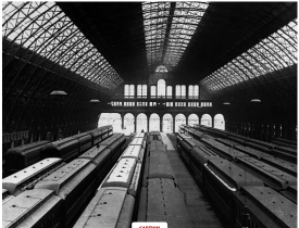 This is an image of the interior of the Grand Central Depot. It was the largest interior space in the entire nation. As shown in the picture, the building’s roof is made out of iron and glass. There are multiple trains within the three railroad lines under the NY Central and Hudson railroad company to show that a large amount of trains went in and out of the Grand Central Depot. 