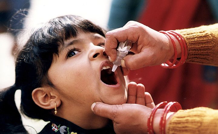 Girl receiving oral polio vaccine. CDC Global/Flickr